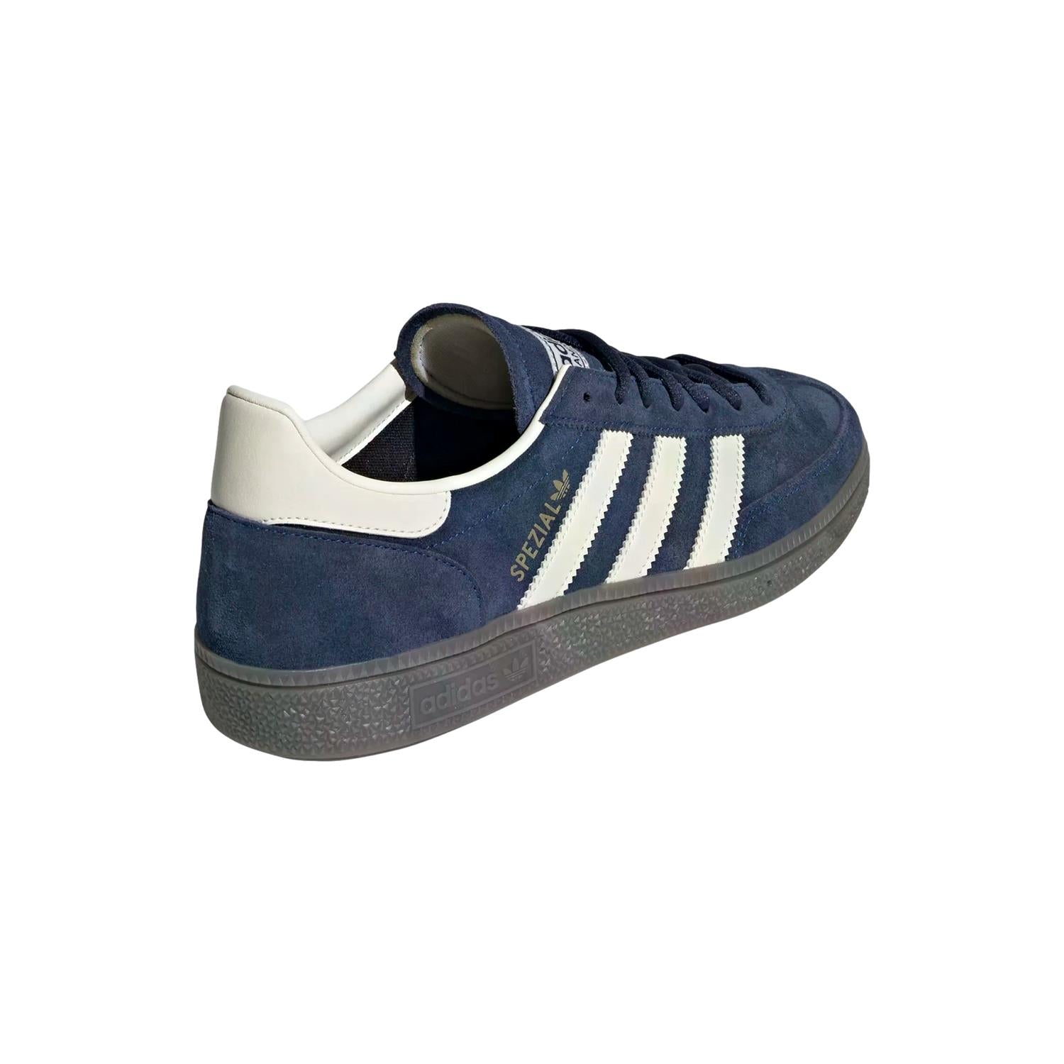 Adidas Handball Spezial sko i mørkeblå med hvite detaljer, vises med nærbilde av skodesign og materialtekstur.