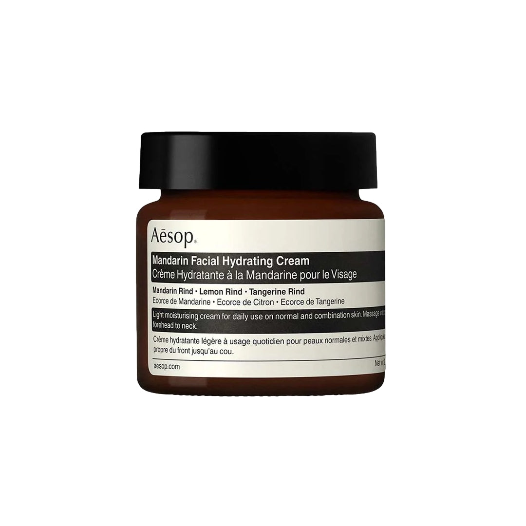 Aesop Mandarin Ansiktskrem i 60 ml, krem med sitrusduft, vises i åpen glaspot med kremtekstur og sitrusfrukter rundt.