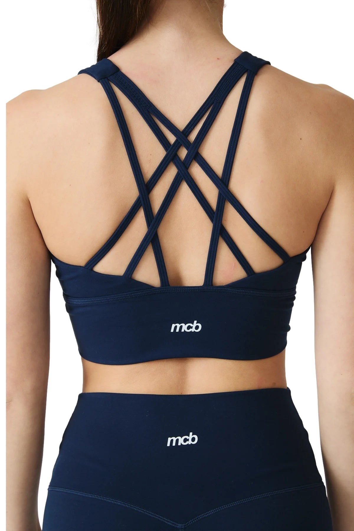 Mørkeblå MCB Sportswear strap-bh topp for trening, med justerbare stropper og komfortabel passform, synlig på bildet.