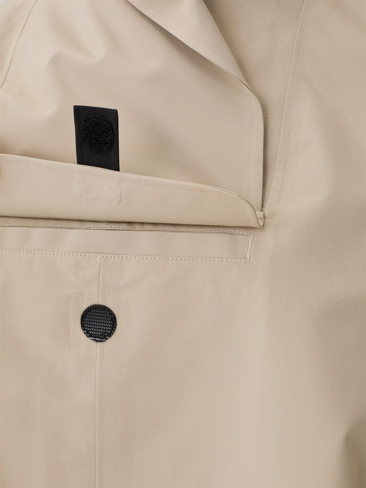 Blæst Bergen Mini Poncho beige jakke, kort og komfortabel med varm beige farge, vist på modell foran en nøytral bakgrunn.