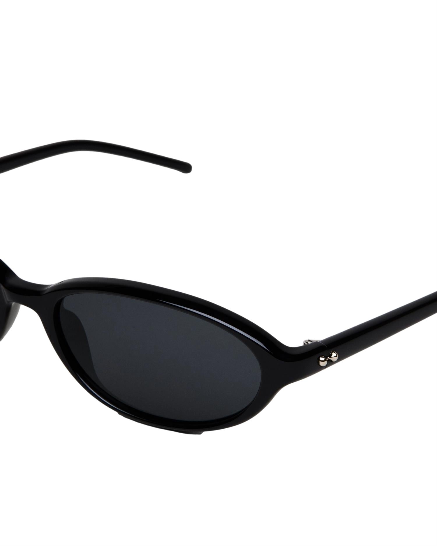 Chimi Eyewear ellipse solbriller i svart med runde rammer, solbeskyttelse og moderne design.