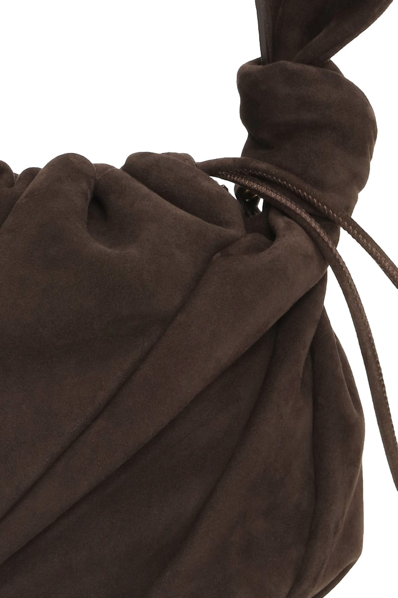 Mørkebrun ROTATE Suede Bon Bon Veske med mykt skinn og elegant design, synlig foran på bildet.