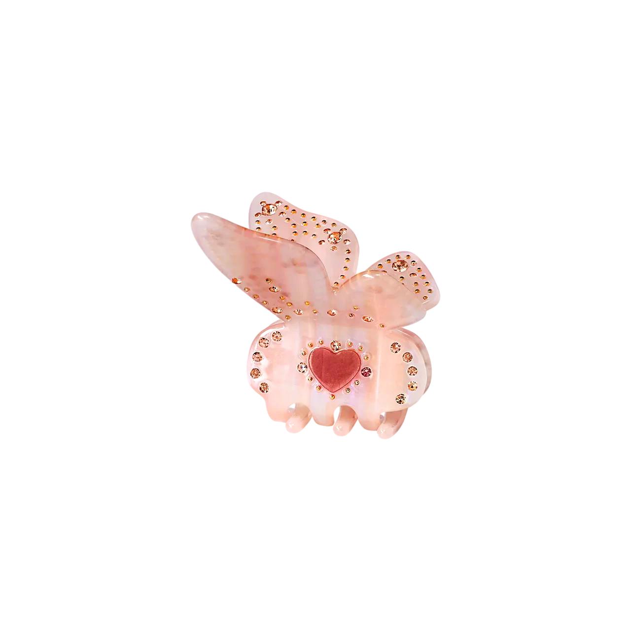Maanesten Flutura hårspenne i lyserosa med blomsterdesign, perfekt for å pynte opp håret.