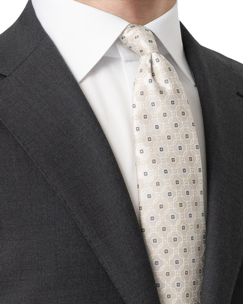 Eton slips av silke med medallion-vevning i lys beige, elegant og luksuriøs slipsdesign.