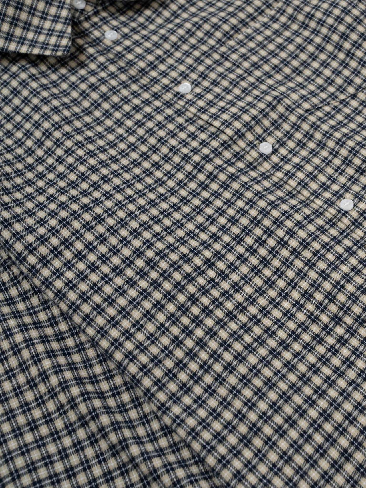 Navy rutete Libertine Libertine skjorte med langermet design, vist brettet og hengt på kleshenger.